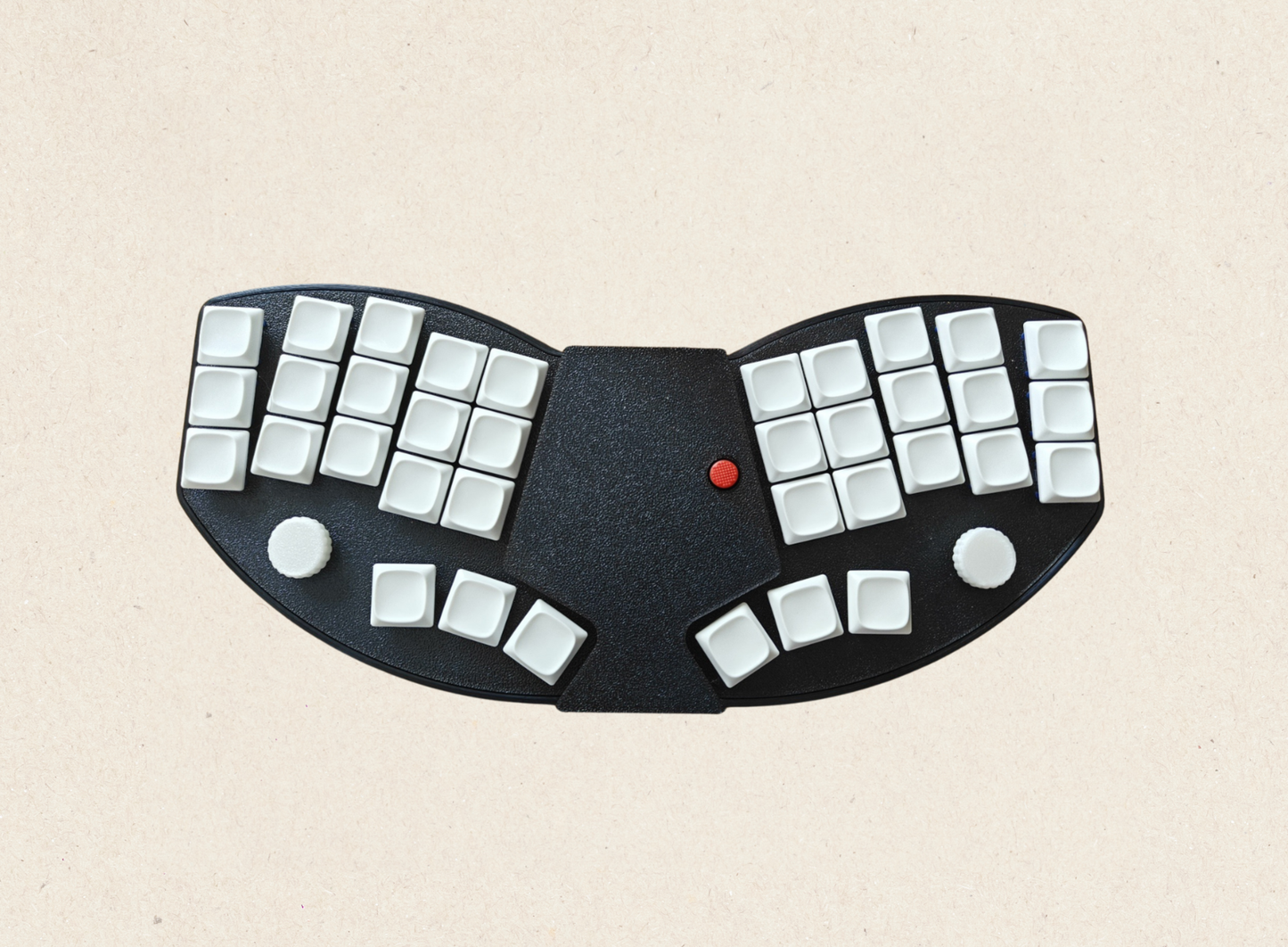 Switch Type: Kailh Choc V1 (hot-swappable)
Layout: 36-key ergonomic
Connection: Bluetooth 5.0 & USB-C wired dual mode
Battery: 750mAh rechargeable (with physical on/off switch)
Software: ZMK Studio (web-based configuration)
More: Dual knobs with press function, full keycap & switch set
✅ TrackPoint (Think-Paad Style) – Built-in red TrackPoint for precise cursor control with adjustable sensitivity, just like on classic ThinkPads.
✅ Dual Connectivity – Seamlessly switch between Bluetooth and USB Wired Mode. 