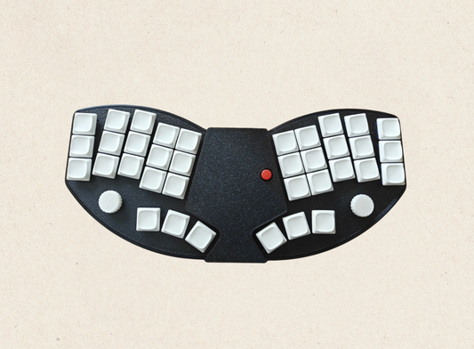 Switch Type: Kailh Choc V1 (hot-swappable)
Layout: 36-key ergonomic
Connection: Bluetooth 5.0 & USB-C wired dual mode
Battery: 750mAh rechargeable (with physical on/off switch)
Software: ZMK Studio (web-based configuration)
More: Dual knobs with press function, full keycap & switch set
✅ TrackPoint (Think-Paad Style) – Built-in red TrackPoint for precise cursor control with adjustable sensitivity, just like on classic ThinkPads.
✅ Dual Connectivity – Seamlessly switch between Bluetooth and USB Wired Mode. 